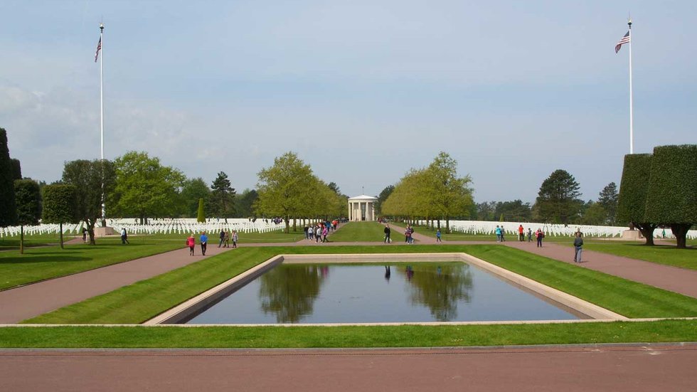 Graves, reflection pool, and chapel at the Normandy American Cemetery overlooking Omaha Beach.