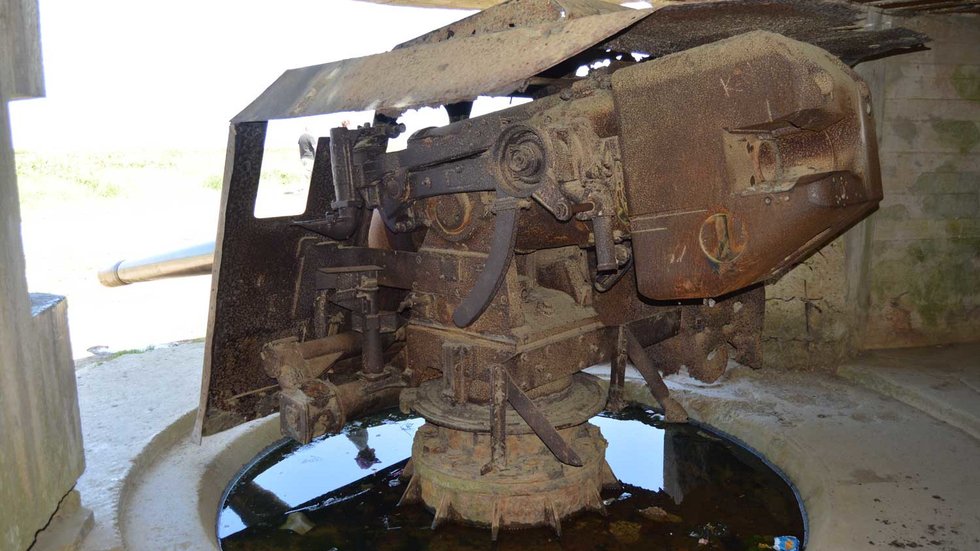 Rear view of a 150 mm gun inside one of the Longues-sur-Mer Battery casemates in Normandy.