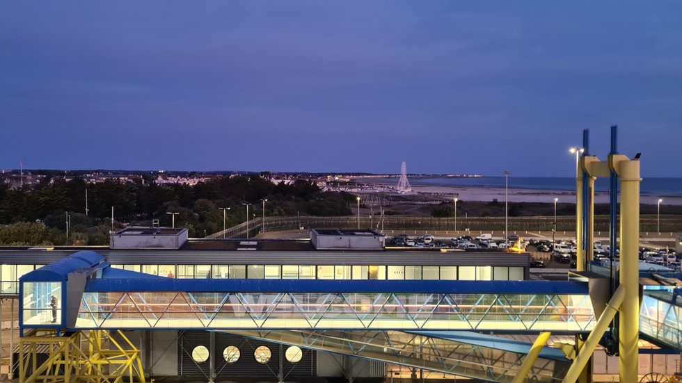 View of Ouistreham beach at dawn from the ferry, with part of the ferry terminal in the foreground