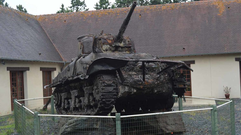 Exterior of Musée des Épaves Sous-Marines with a recovered M4 Sherman DD tank on display