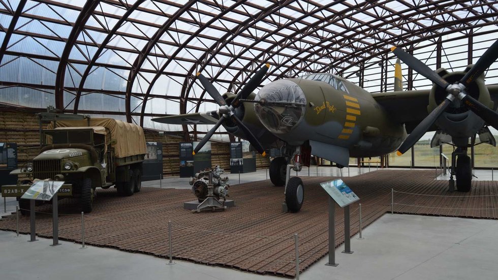 Restored B-26 Marauder bomber and U.S. military truck on display at the Utah Beach Museum