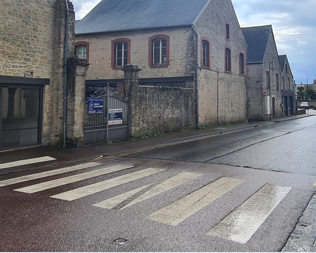 1944 Sainte Mere Eglise, wounded being taken to hospital on jeep, location today
