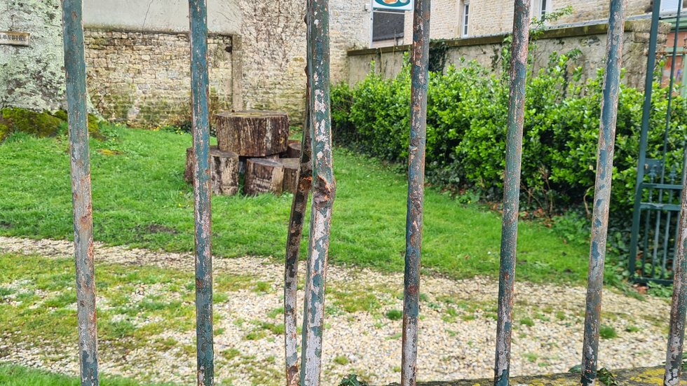 Close-up of bullet-damaged railings in the town square