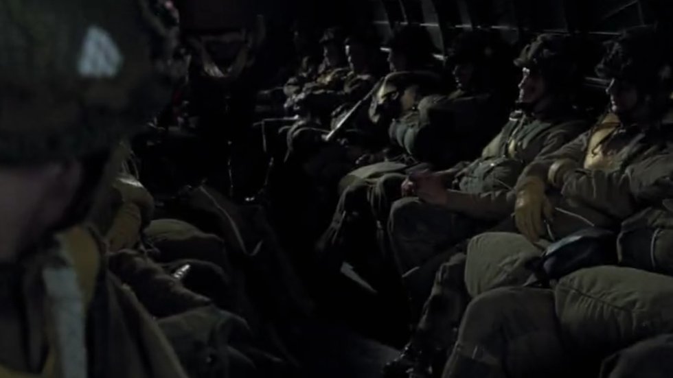 Paratroopers seated inside the C-47 on the flight to Normandy in Band of Brothers