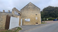 Wide view of the Étréham 1st US Infantry Division memorial on the wall of the Mairie opposite Église Saint-Romain