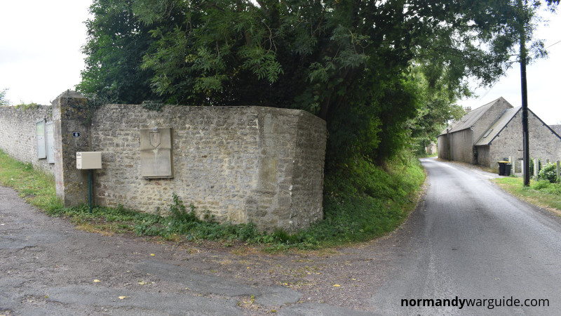 Wide view of the memorial plaque honoring the 1st U.S. Infantry Division at Russy Mairie, Normandy