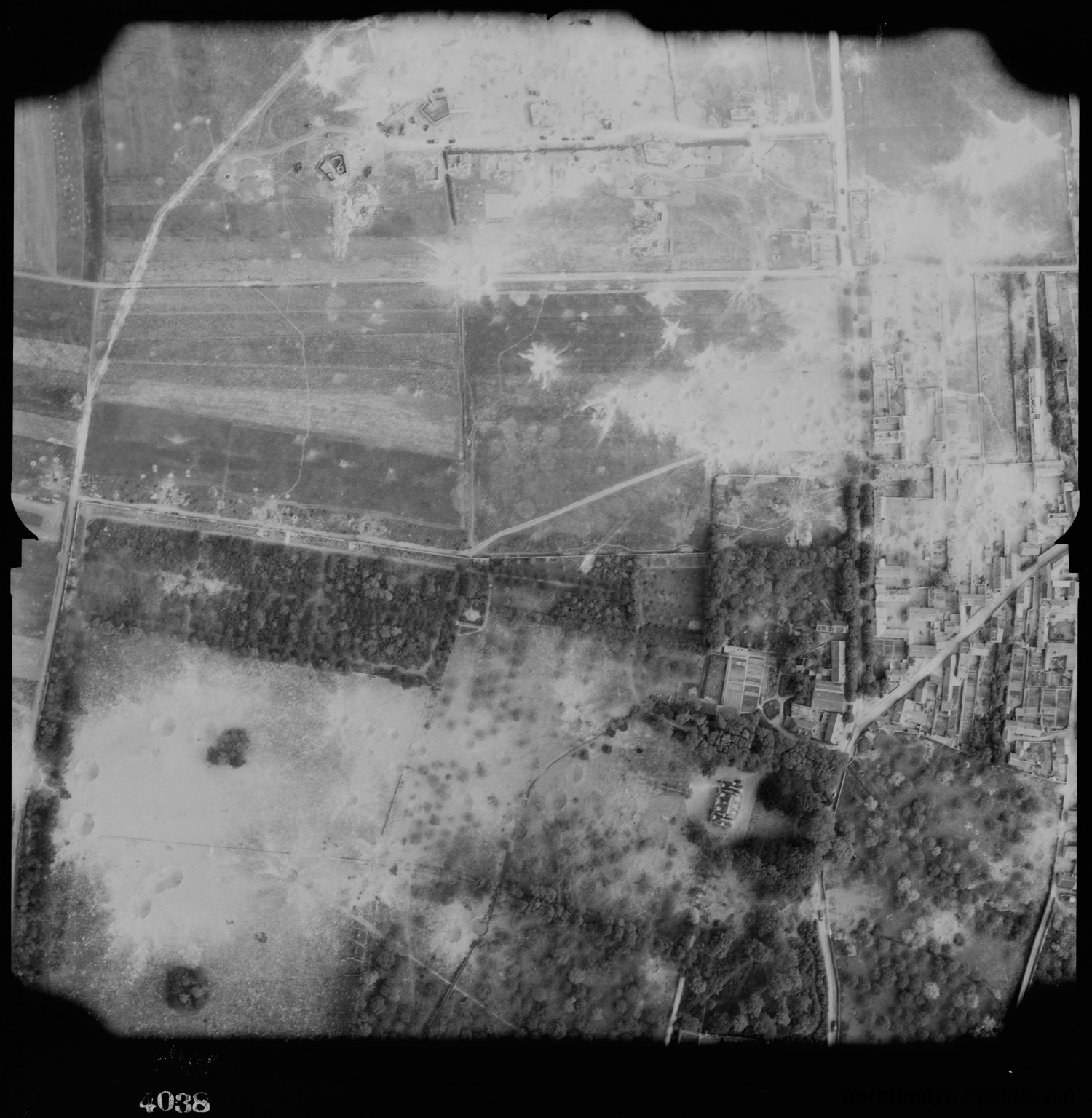 An aerial image of Mont Fleury Battery from D-Day showing bomb craters.